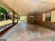 Covered patio with concrete floor, brick walls, and a view of the backyard at 360 Meadowbrook Dr, Mcdonough, GA 30253