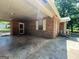 A covered patio with concrete flooring, brick columns, and a view of the yard at 360 Meadowbrook Dr, Mcdonough, GA 30253