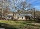 Exterior back view of home with covered parking at 360 Meadowbrook Dr, Mcdonough, GA 30253