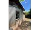 Close up of shed, displaying corrugated metal exterior and deteriorating window at 360 Meadowbrook Dr, Mcdonough, GA 30253