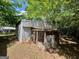 Exterior of shed with corrugated metal walls surrounded by trees at 360 Meadowbrook Dr, Mcdonough, GA 30253