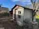 Small shed with a red door and concrete block foundation at 360 Meadowbrook Dr, Mcdonough, GA 30253