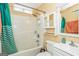 Bathroom with a shower-tub combo, mirrored cabinet, and a modern single-sink vanity at 3435 Pierce Arrow Cir, Suwanee, GA 30024