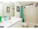 Cozy bathroom featuring a shower with a green-striped curtain and updated vanity at 3435 Pierce Arrow Cir, Suwanee, GA 30024