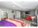 Finished basement bedroom with a tv and a small red sofa at 3435 Pierce Arrow Cir, Suwanee, GA 30024