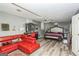 Modern bedroom with a red sofa, dresser, and hardwood floors at 3435 Pierce Arrow Cir, Suwanee, GA 30024