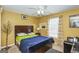 Comfortable bedroom featuring a ceiling fan, window with natural light, and hardwood floors at 3435 Pierce Arrow Cir, Suwanee, GA 30024