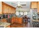 Kitchen with stainless steel appliances, wood cabinets, and a dining area at 3435 Pierce Arrow Cir, Suwanee, GA 30024