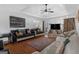 Spacious living room with modern couches, tray ceilings, and hardwood floors at 3435 Pierce Arrow Cir, Suwanee, GA 30024