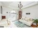 Elegant living room with tray ceilings, a chandelier, and comfortable seating at 3435 Pierce Arrow Cir, Suwanee, GA 30024