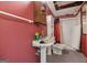 Basement bathroom featuring vintage sink and shower, and retro-red wall at 2200 Gleneagle Nw Ct, Conyers, GA 30012