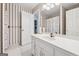 Bathroom featuring white cabinets, patterned wallpaper, and a combined shower and tub area, a cozy design at 2200 Gleneagle Nw Ct, Conyers, GA 30012