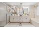 Bright bathroom featuring a double vanity, tiled flooring, and separate shower and tub at 2200 Gleneagle Nw Ct, Conyers, GA 30012