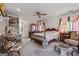 Cozy bedroom featuring a ceiling fan, wood furnishings, and an ensuite bathroom at 2200 Gleneagle Nw Ct, Conyers, GA 30012