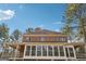 Large brick home with a covered porch and a wall of windows for optimal light at 2200 Gleneagle Nw Ct, Conyers, GA 30012