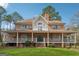Charming brick home featuring a spacious wrap-around porch and well-maintained lawn at 2200 Gleneagle Nw Ct, Conyers, GA 30012