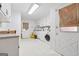 Bright laundry room featuring a washer and dryer and ample cabinet space at 2200 Gleneagle Nw Ct, Conyers, GA 30012