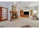 Cozy living room featuring a brick fireplace, built-in shelving, and plush carpeting, perfect for relaxation at 2200 Gleneagle Nw Ct, Conyers, GA 30012