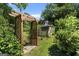 View of backyard with greenery, wooden trellis, and shed at 2612 New Haven Dr, Jonesboro, GA 30236