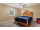 Comfortable bedroom features a wood bed frame, neutral carpet, and soft, natural light at 2612 New Haven Dr, Jonesboro, GA 30236