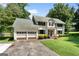 Inviting home featuring a well-maintained lawn, a spacious two-car garage and traditional architectural details at 2612 New Haven Dr, Jonesboro, GA 30236