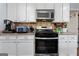 Well-equipped kitchen showcasing stainless steel appliances and white cabinets at 2612 New Haven Dr, Jonesboro, GA 30236