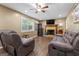 Inviting living room with a cozy fireplace, plush seating, and a ceiling fan for added comfort at 2612 New Haven Dr, Jonesboro, GA 30236