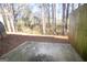 Home backyard with a concrete patio and natural surroundings at 6342 Kinsland Ct, Lithonia, GA 30058