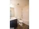 Standard bathroom with tile flooring, vanity with a single sink, toilet, and tub with tiled walls at 6342 Kinsland Ct, Lithonia, GA 30058