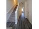 Bright foyer with hardwood flooring and stairway is ready to greet Gathering and friends at 6342 Kinsland Ct, Lithonia, GA 30058