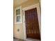 Inviting front door with sidelight and clear house number is ready to welcome you home at 6342 Kinsland Ct, Lithonia, GA 30058