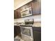 Close-up of the kitchen, featuring granite countertops and stainless steel appliances at 6342 Kinsland Ct, Lithonia, GA 30058