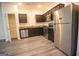 Modern kitchen features stainless steel appliances, granite countertops and hardwood flooring at 6342 Kinsland Ct, Lithonia, GA 30058
