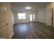 Spacious living room with hardwood flooring, plenty of natural light, and access to the backyard at 6342 Kinsland Ct, Lithonia, GA 30058