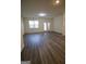 The living room with hardwood flooring and a door to the backyard is very inviting at 6342 Kinsland Ct, Lithonia, GA 30058