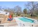 Serene backyard showcasing a pool, wooden deck with outdoor seating, and mature trees offering shade at 8 Cameron St, Moreland, GA 30259
