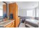 Bathroom featuring double sinks, soaking tub, tiled floors, and wood cabinets at 8 Cameron St, Moreland, GA 30259