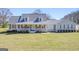Charming single-Gathering home with a covered front porch and well-manicured lawn on a sunny day at 8 Cameron St, Moreland, GA 30259