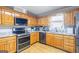 Modern kitchen boasting stainless steel appliances, granite countertops, and stylish hardwood cabinetry at 8 Cameron St, Moreland, GA 30259