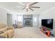 Bright living room showcasing a stone fireplace, comfortable furniture, and a large television at 8 Cameron St, Moreland, GA 30259