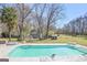 Inviting swimming pool surrounded by lush greenery and comfortable lounge chairs, creating a relaxing oasis at 8 Cameron St, Moreland, GA 30259