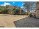 Vast backyard with well-maintained lawn and view of the home featuring a covered patio area at 2441 Noelle Ln, Powder Springs, GA 30127