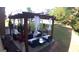 Secluded backyard patio with a pergola, draped in sheer curtains, surrounded by lush greenery at 2441 Noelle Ln, Powder Springs, GA 30127