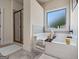 Relaxing bathroom featuring a soaking tub with decorative accents and a separate glass shower at 2441 Noelle Ln, Powder Springs, GA 30127
