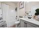 Clean bathroom with a shower-tub combo, white vanity, and decorative accents at 2441 Noelle Ln, Powder Springs, GA 30127