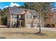 Traditional brick home with a three-car garage and a well-manicured front lawn with mature trees at 2441 Noelle Ln, Powder Springs, GA 30127