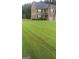 Beautifully manicured lawn leading to a traditional two-story home with a well-maintained exterior at 2441 Noelle Ln, Powder Springs, GA 30127