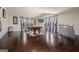 Expansive game room with a pool table, bar, and hardwood floors, illuminated by natural light from several windows at 2441 Noelle Ln, Powder Springs, GA 30127