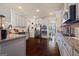 Spacious kitchen with stainless steel appliances, granite countertops, and dark hardwood floors at 2441 Noelle Ln, Powder Springs, GA 30127