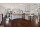 Open-concept kitchen featuring white cabinetry, granite countertops, stainless steel appliances, and dark hardwood floors at 2441 Noelle Ln, Powder Springs, GA 30127